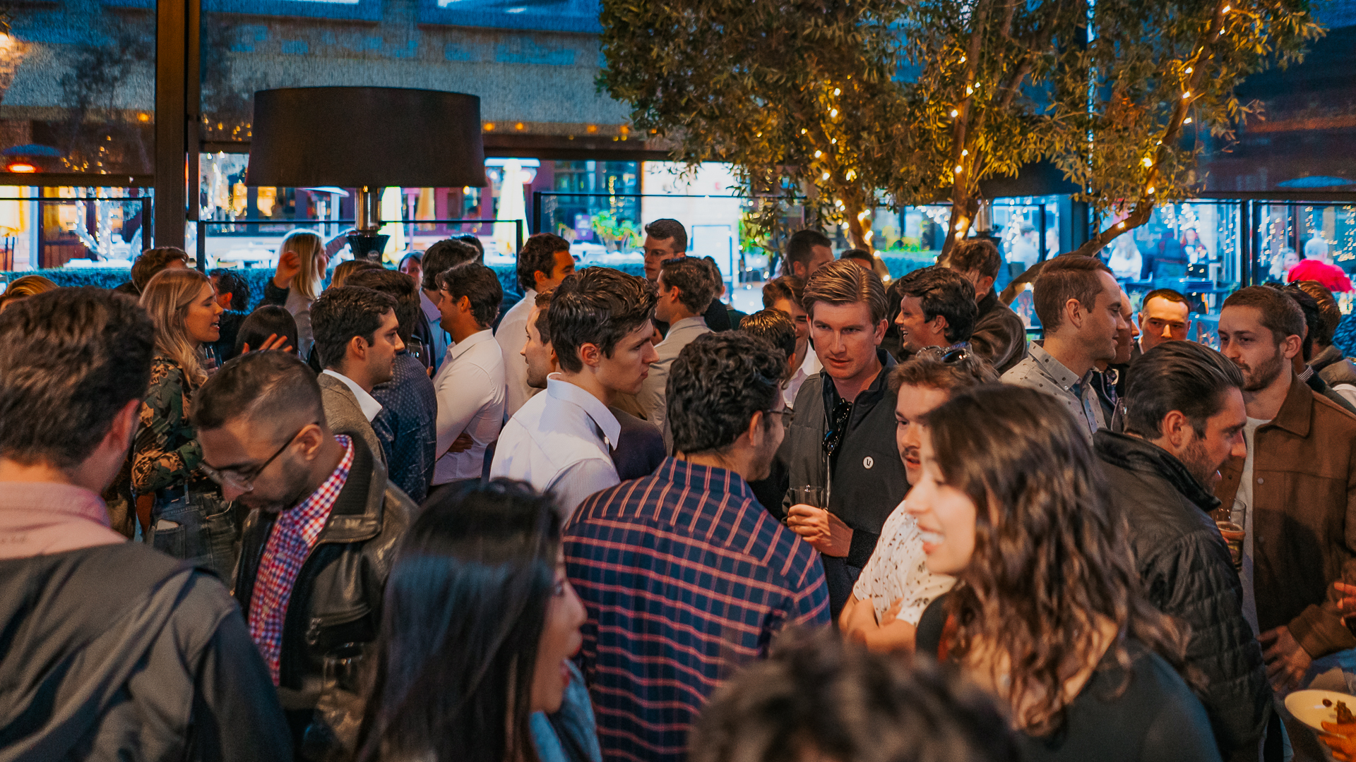 A First Friday event with happy people in a crowd at a First Fridays CRE event at The Winery, La Jolla, San Diego.